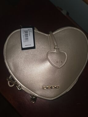 bebe Metallic Heart Crossbody Bag in Champagne Gold
